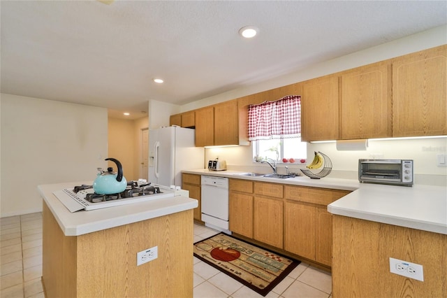 kitchen with a center island with sink, white appliances, sink, and light tile floors