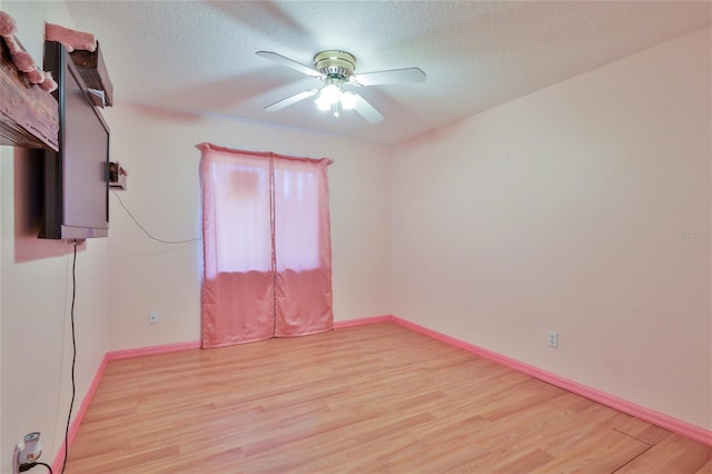 unfurnished room with a textured ceiling, ceiling fan, and light hardwood / wood-style flooring