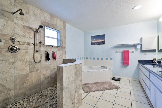 bathroom featuring tile floors, a textured ceiling, vanity, and independent shower and bath