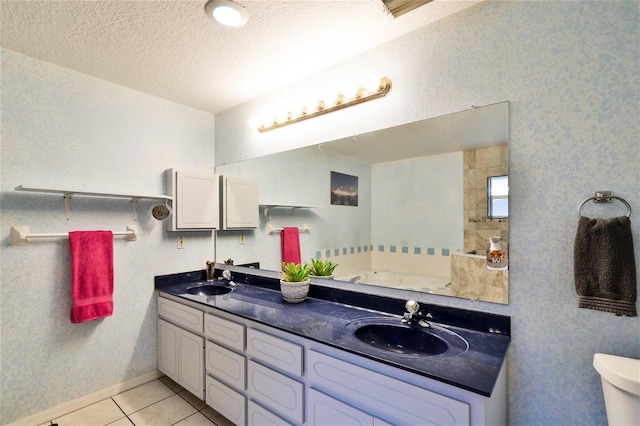 bathroom with dual sinks, a textured ceiling, tile flooring, toilet, and oversized vanity