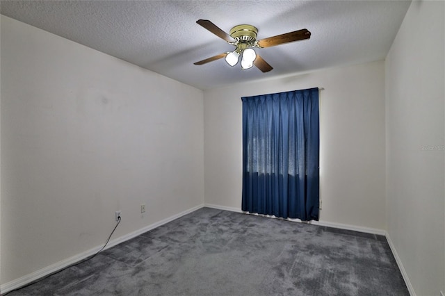 unfurnished room featuring dark colored carpet, ceiling fan, and a textured ceiling