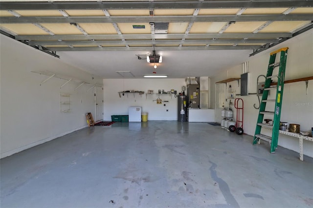 garage with a garage door opener, water heater, washer / dryer, and heating utilities