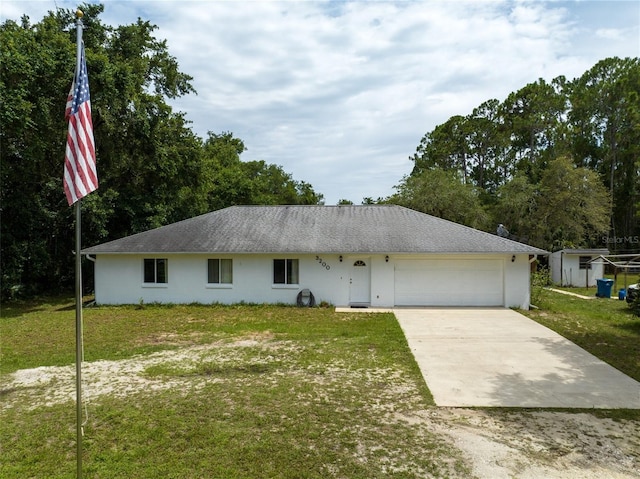 ranch-style house with a front yard, a storage unit, and a garage