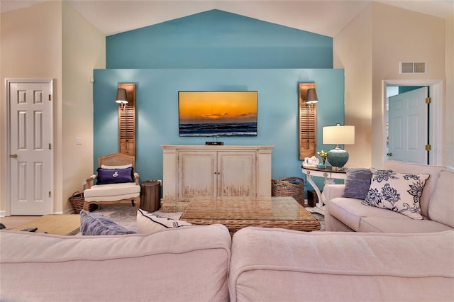 living room with high vaulted ceiling