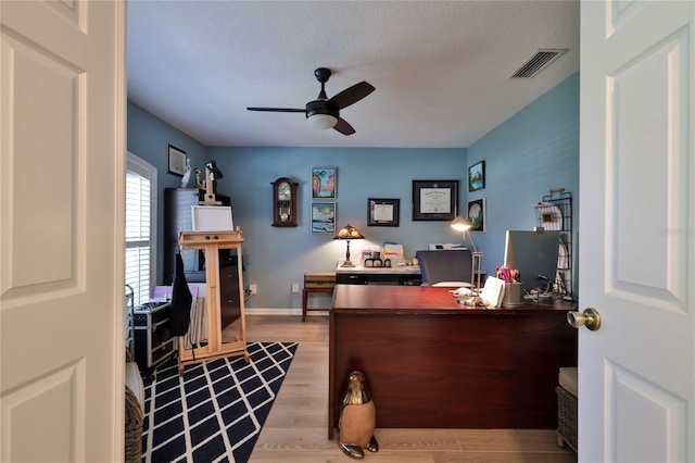 office space with light hardwood / wood-style floors and ceiling fan