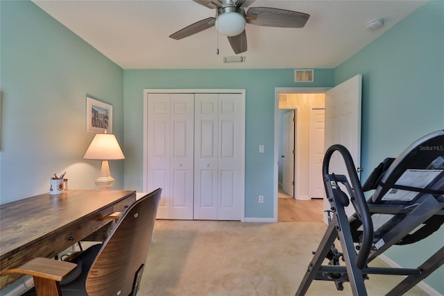 carpeted home office featuring ceiling fan