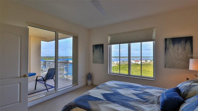 263 Minorca Beach Way Unit 803, New Smyrna Beach, FL 32169 - bedroom with a water view, access to exterior, ceiling fan, and light colored carpet