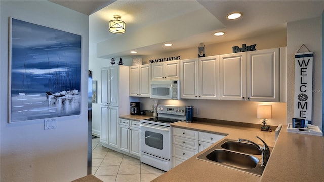 263 Minorca Beach Way Unit 803, New Smyrna Beach, FL 32169 - kitchen featuring white appliances, sink, white cabinetry, and light tile flooring