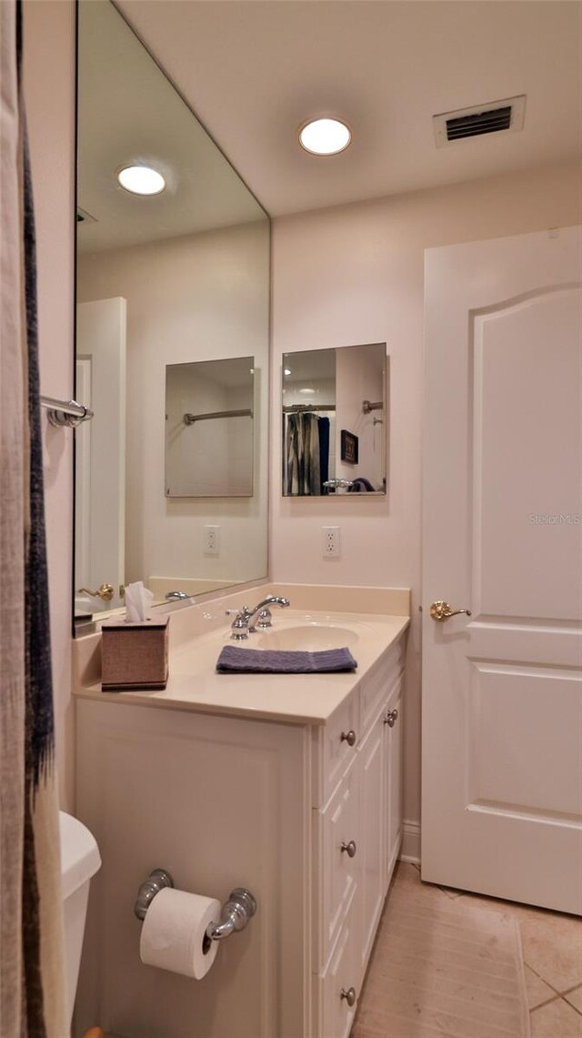 263 Minorca Beach Way Unit 803, New Smyrna Beach, FL 32169 - bathroom featuring toilet and vanity with extensive cabinet space