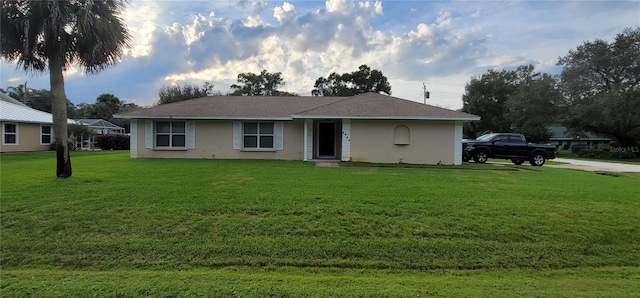 ranch-style house with a front lawn