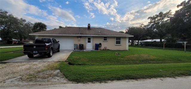 ranch-style house featuring a front lawn and a garage