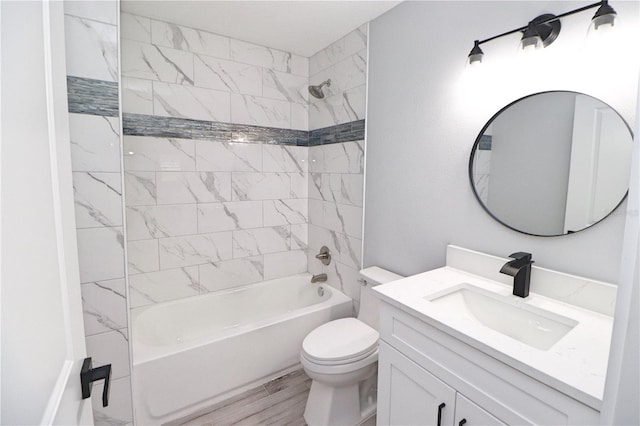 full bathroom with tiled shower / bath combo, toilet, and vanity with extensive cabinet space