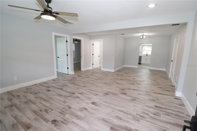 spare room featuring ceiling fan and light hardwood / wood-style flooring