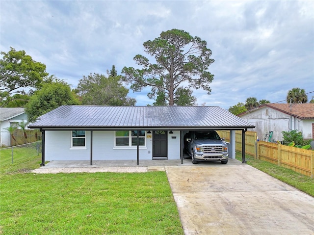 single story home featuring a front yard, covered porch, and a carport