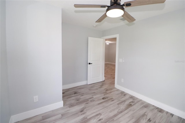 empty room with light hardwood / wood-style floors and ceiling fan