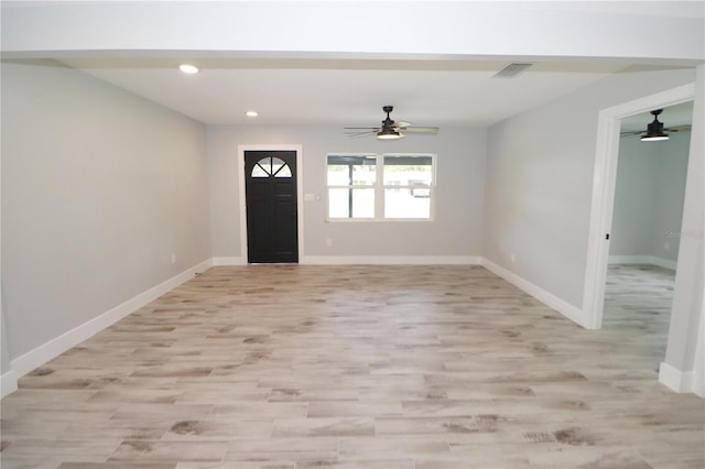 foyer entrance with light hardwood / wood-style floors and ceiling fan