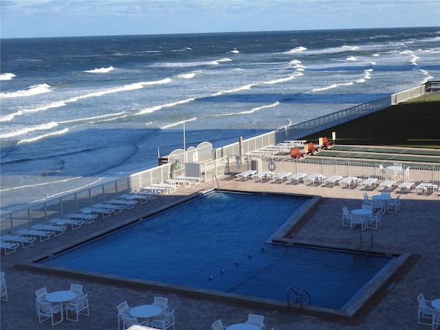 view of pool with a water view