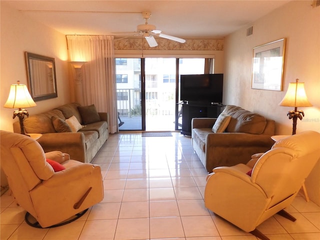 tiled living room with plenty of natural light and ceiling fan