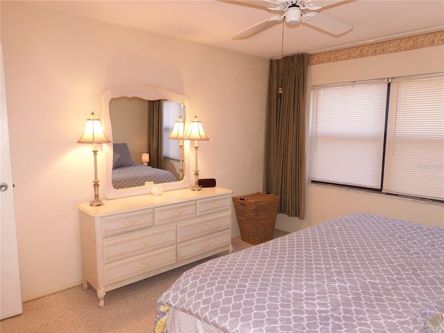 bedroom with light colored carpet and ceiling fan