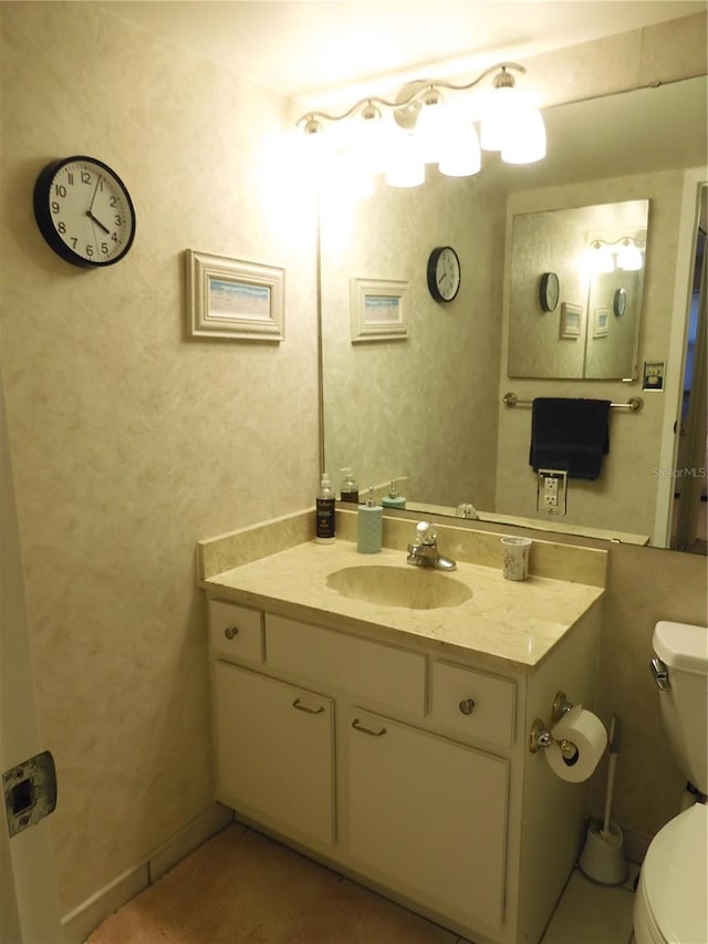 bathroom featuring vanity and toilet