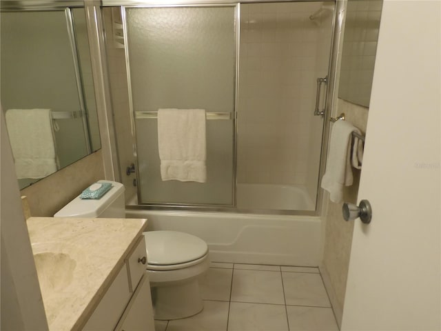 full bathroom with enclosed tub / shower combo, toilet, vanity, and tile flooring