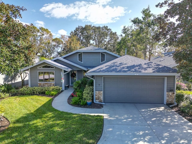 view of front of home with a front lawn and a garage