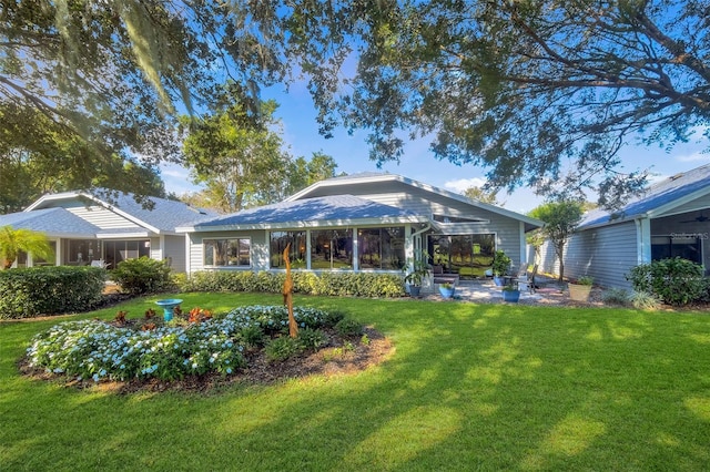 rear view of house with a lawn and a patio area