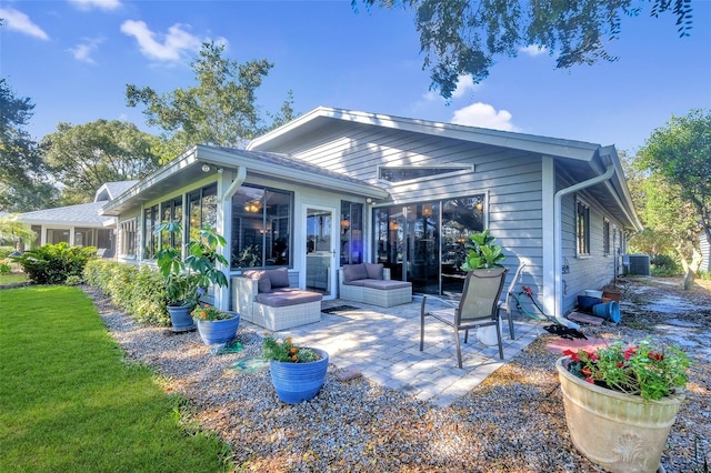 rear view of property featuring an outdoor hangout area, central AC, and a patio