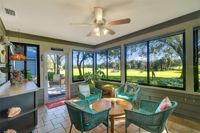 sunroom / solarium featuring ceiling fan