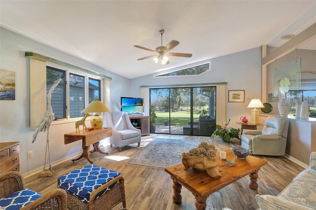 living room with lofted ceiling, wood-type flooring, ceiling fan, and a healthy amount of sunlight