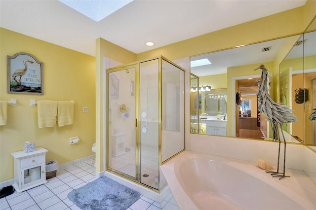 full bathroom featuring separate shower and tub, toilet, tile floors, and vanity