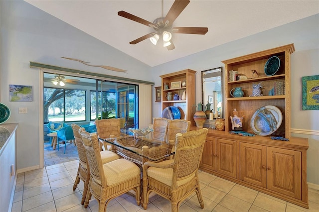 tiled dining space featuring ceiling fan and vaulted ceiling