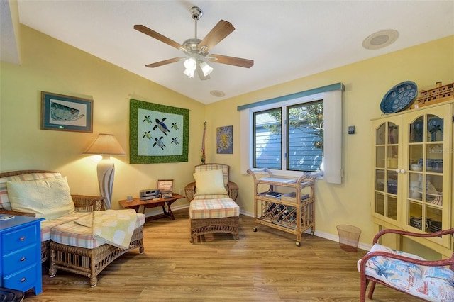 living area featuring light wood-type flooring, ceiling fan, and lofted ceiling