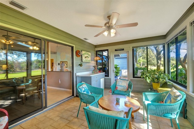 sunroom featuring ceiling fan