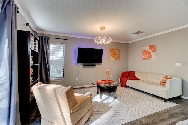 living room with crown molding, dark hardwood / wood-style floors, and an inviting chandelier