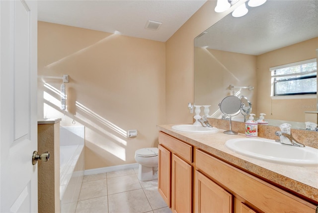 bathroom with toilet, dual sinks, tile flooring, a textured ceiling, and large vanity