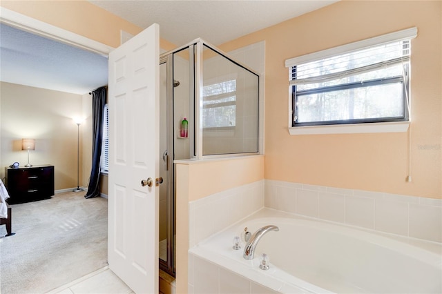 bathroom featuring separate shower and tub