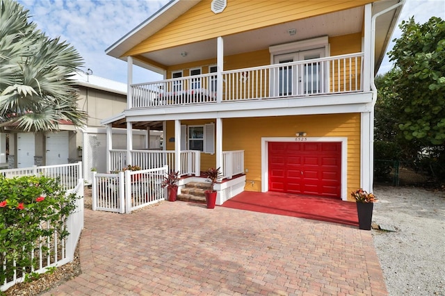 view of front facade featuring a balcony and a garage