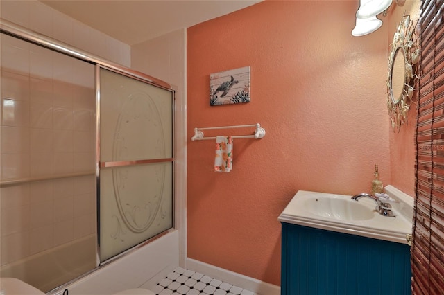 full bathroom with enclosed tub / shower combo, toilet, tile floors, and vanity