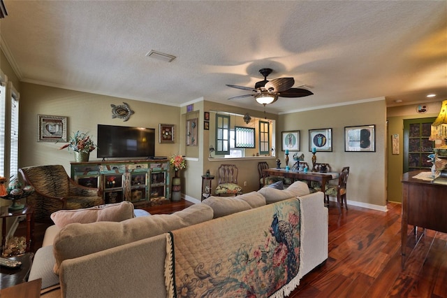 living room featuring dark hardwood / wood-style floors, ornamental molding, a textured ceiling, and ceiling fan