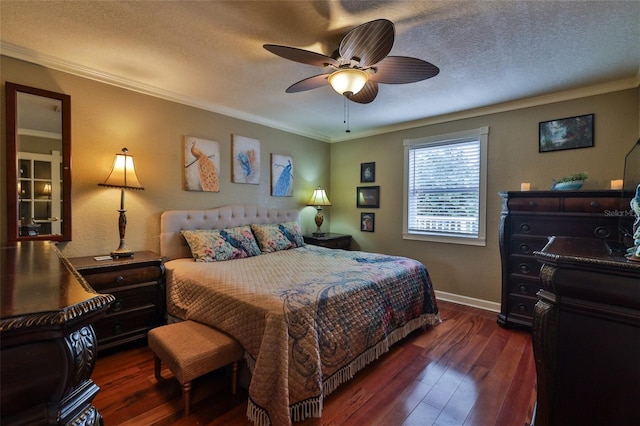 bedroom with ceiling fan, a textured ceiling, dark wood-type flooring, and ornamental molding