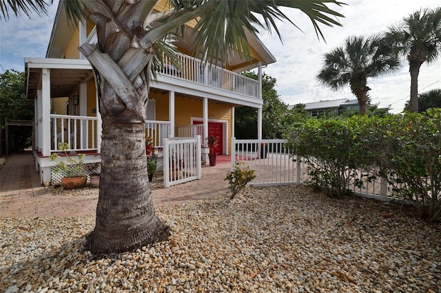 view of front of house featuring a porch and a balcony