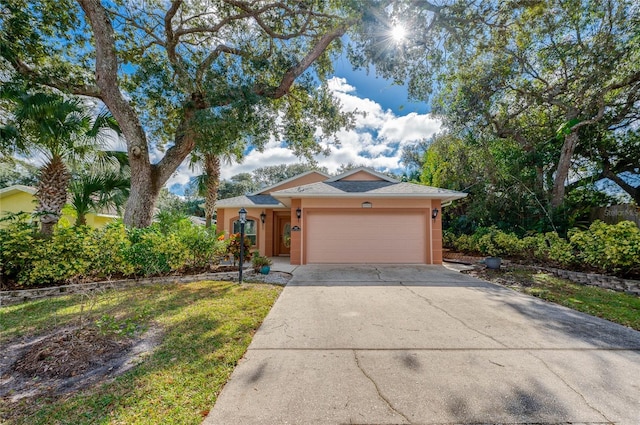 ranch-style home with a front lawn and a garage