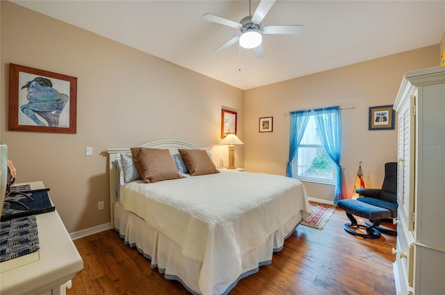 bedroom with ceiling fan and dark hardwood / wood-style flooring