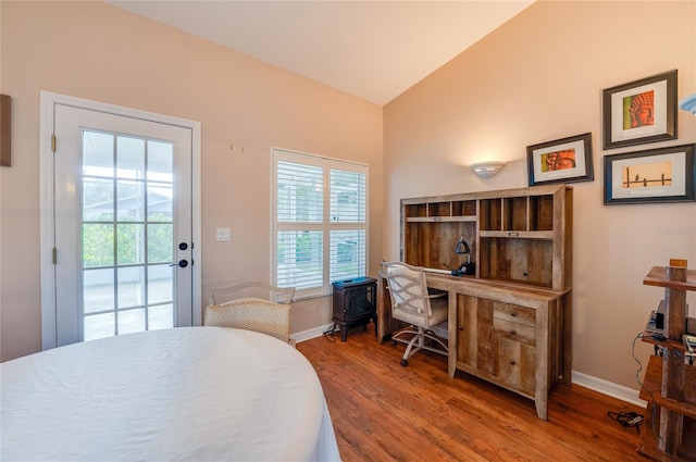 bedroom with lofted ceiling, wood-type flooring, access to outside, and multiple windows