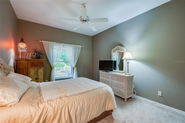 bedroom featuring light colored carpet and ceiling fan