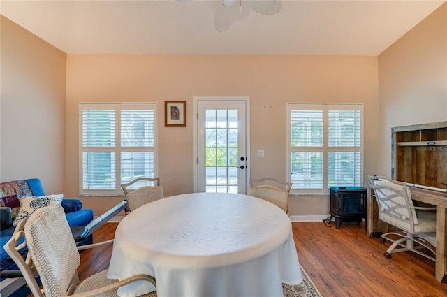 dining area with dark hardwood / wood-style floors and ceiling fan