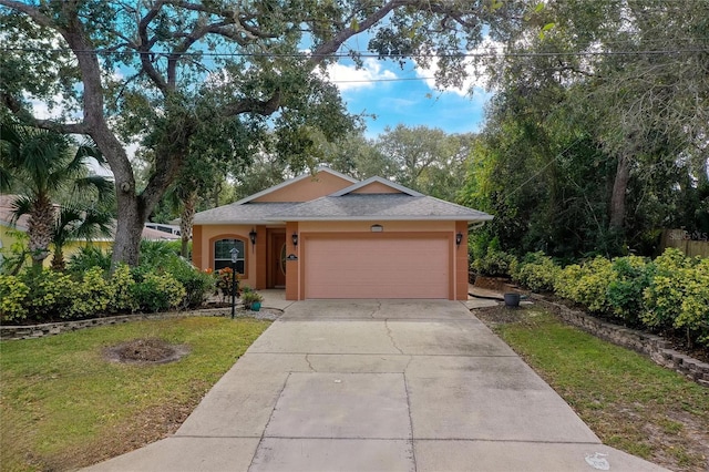 ranch-style house with a front lawn and a garage