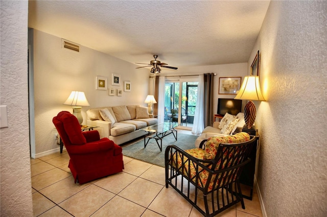 tiled living room featuring ceiling fan and a textured ceiling