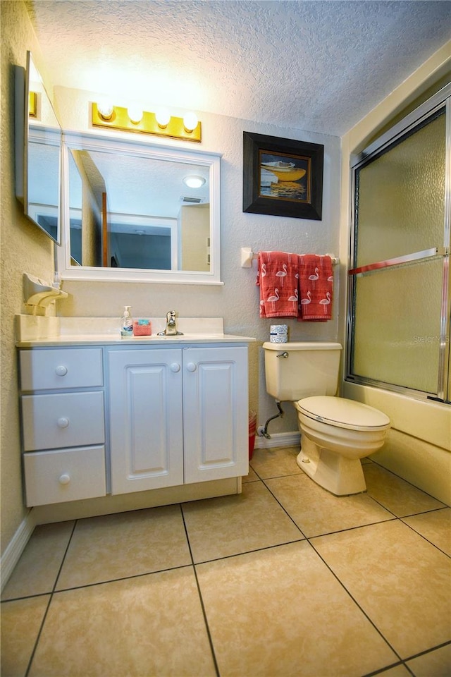 full bathroom with a textured ceiling, tile floors, oversized vanity, and toilet